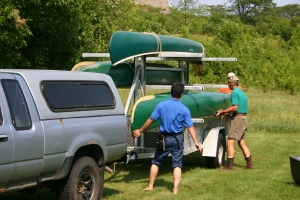 Loading canoes on the trailer after the trip.