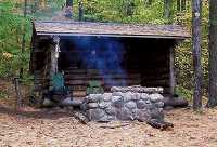 Adirondack lean to, with cooking fire.